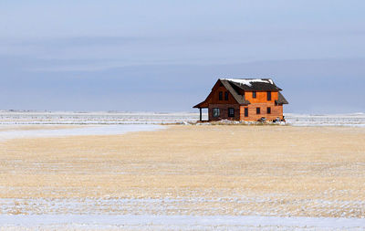 Lifeguard hut on beach against sky