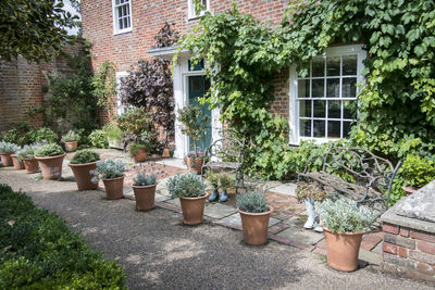 Cottage and garden with benches and ornamental pots