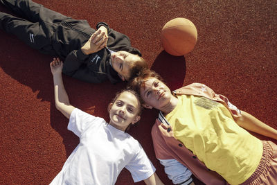 Laid-back laughter, unwinding with children on the basketball court surface