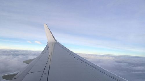 Close-up of airplane wing against sky