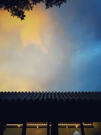 Low angle view of silhouette building against sky at sunset