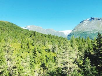 Scenic view of mountains against clear blue sky