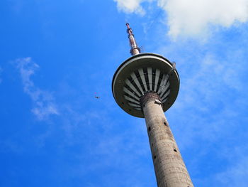 Low angle view of communications tower against sky