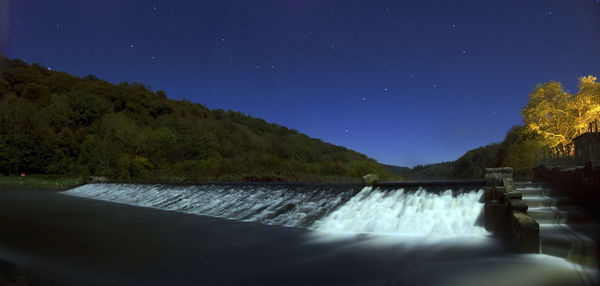 Scenic view of lake against sky at night