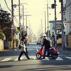 Woman riding bicycle on city street