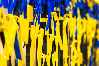 Ribbons with colors of ukraine during peaceful demonstration against war, ukrainian flag background