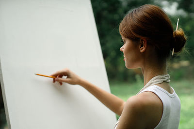 Portrait of woman holding cigarette