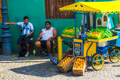 Young men sitting on wall