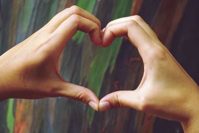 Cropped image of hands making heart shape