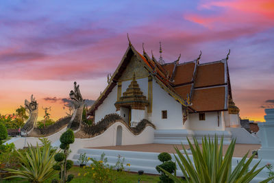 Traditional building against sky during sunset