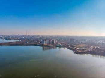 High angle view of river and buildings against sky