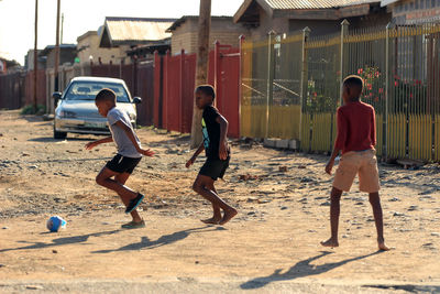 People playing soccer at beach