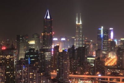 Low angle view of skyscrapers lit up at night