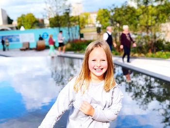 Portrait of a smiling young woman in swimming pool