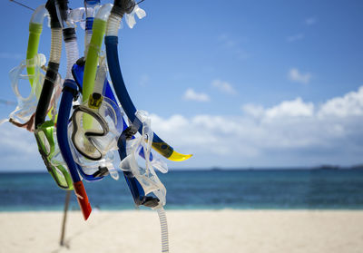 Close-up of umbrella on beach against sky