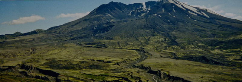 Scenic view of mountains against cloudy sky