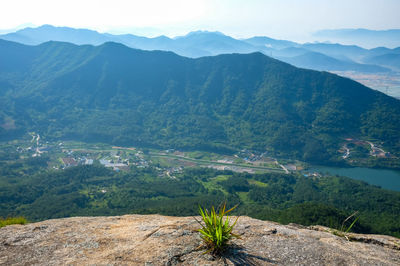 High angle view of lake amidst mountains against sky