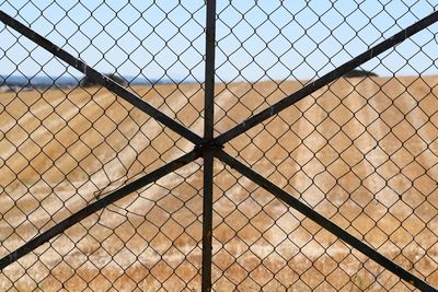 Full frame shot of chainlink fence against sky