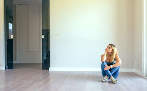 Young woman sitting on floor