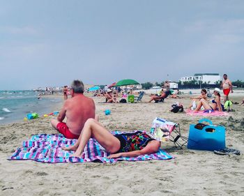 People relaxing on beach