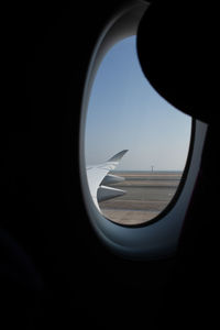 Close-up of airplane window against clear sky