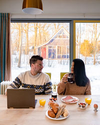 Couple sitting by table