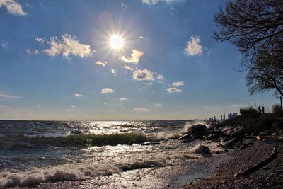 Scenic view of sea against bright sun