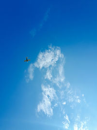 Low angle view of airplane flying in sky