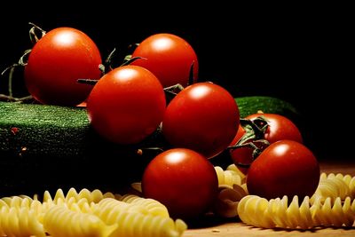 Close-up of raw pasta with vegetables on table