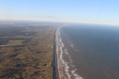 High angle view of land and sea against sky