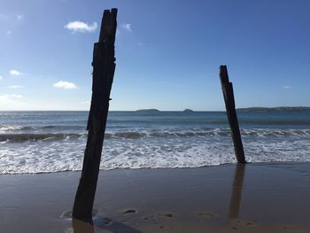 Scenic view of beach against blue sky