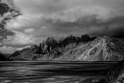 Scenic view of mountains against cloudy sky