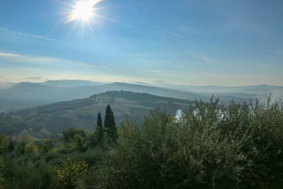 Scenic view of mountains against sky on sunny day