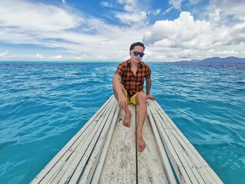 Full length of man standing on sea against sky