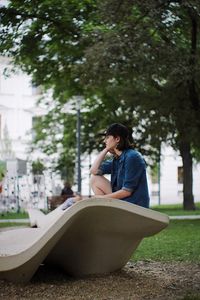 Young woman sitting in park