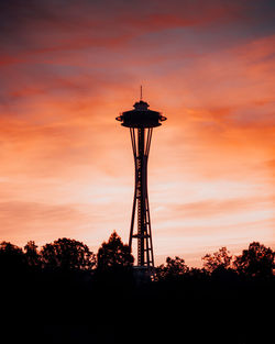 Low angle view of tower against cloudy sky during sunset