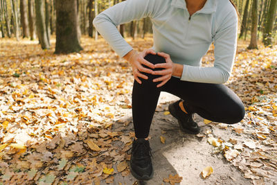 Low section of woman sitting on field