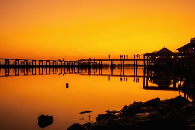 Scenic view of sea against orange sky