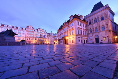 Illuminated buildings in city at dusk