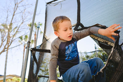 Close-up of boy entering trampoline