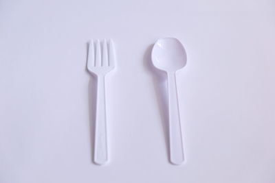 Directly above shot of fork over white background