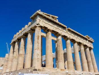 Low angle view of historical building against blue sky