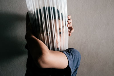 Low section of woman standing by wall