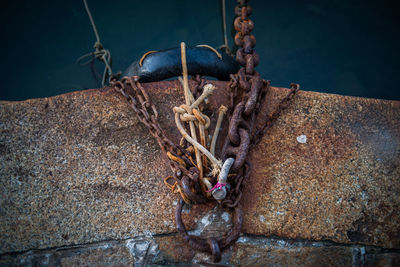 High angle view of rusty chain on port over sea