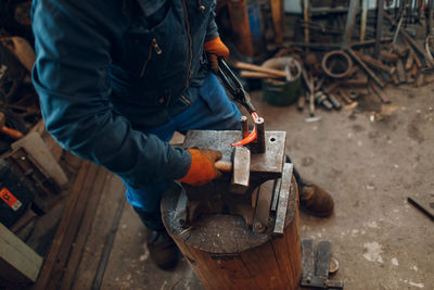 Low section of man working at workshop