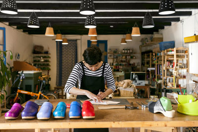 Clogmaker working in her workshop