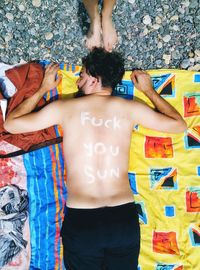 Midsection of young woman standing against multi colored wall