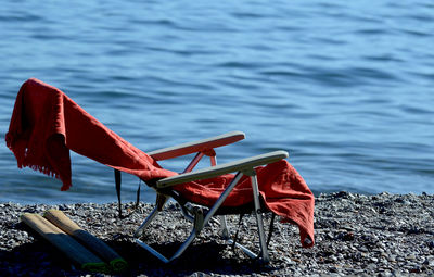 Chairs on beach by lake