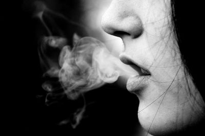 Cropped image of woman smoking