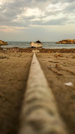 Surface level of empty beach against sky